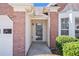 Close-up of the home's front door framed by brick, enhanced with manicured shrubs at 2794 Hillvale Cove Way, Lithonia, GA 30058