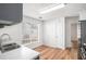 Bright kitchen area with gray cabinets, stainless steel appliances, and wood-look flooring at 2794 Hillvale Cove Way, Lithonia, GA 30058