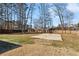 Large backyard with a basketball court, trees, and a wooden fence at 3185 Perch Sw Dr, Marietta, GA 30008