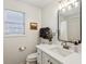 Bathroom with white vanity, black framed mirror, and natural light at 3185 Perch Sw Dr, Marietta, GA 30008