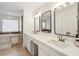 Bright bathroom with double vanity, quartz countertop, framed mirrors, soaking tub and walk-in shower at 3185 Perch Sw Dr, Marietta, GA 30008