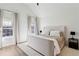 Serene bedroom with neutral decor, vaulted ceiling, and abundant natural light from two windows at 3185 Perch Sw Dr, Marietta, GA 30008