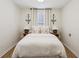 Cozy bedroom with neutral walls, hardwood floors, and a window with decorative sconces at 3185 Perch Sw Dr, Marietta, GA 30008