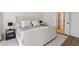 Bright bedroom featuring neutral decor, warm toned linens, and view of ensuite bathroom at 3185 Perch Sw Dr, Marietta, GA 30008