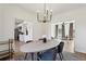 Bright dining room showcasing modern chandelier, round table with seating, and open floorplan at 3185 Perch Sw Dr, Marietta, GA 30008