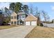 Charming two-story home featuring a brick and gray exterior, complemented by a spacious driveway and garage at 3185 Perch Sw Dr, Marietta, GA 30008