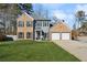 Charming two-story home with brick and siding, a well-manicured lawn, and an attached two-car garage at 3185 Perch Sw Dr, Marietta, GA 30008