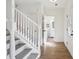 Inviting foyer features pristine white walls, hardwood flooring, and staircase leading to the upper level at 3185 Perch Sw Dr, Marietta, GA 30008