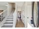 Bright foyer with hardwood floors, a staircase, and views into the adjacent kitchen and living spaces at 3185 Perch Sw Dr, Marietta, GA 30008