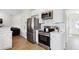 Stylish kitchen featuring stainless steel appliances and white cabinets with breakfast bar at 3185 Perch Sw Dr, Marietta, GA 30008