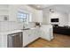 Well-lit kitchen boasting white cabinets, stainless steel appliances, and open to living area at 3185 Perch Sw Dr, Marietta, GA 30008