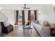 Comfortable living room with hardwood floors, featuring plush seating and abundant natural light from the windows at 3185 Perch Sw Dr, Marietta, GA 30008