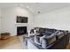 Comfortable living room with fireplace, modern ceiling fan, vaulted ceilings, and stylish sectional couch at 3185 Perch Sw Dr, Marietta, GA 30008