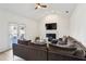 Inviting living room features a vaulted ceiling, modern ceiling fan, fireplace, and access to outdoor space at 3185 Perch Sw Dr, Marietta, GA 30008