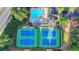 Overhead view of community tennis courts, clubhouse and pool surrounded by mature trees and lush landscaping at 5435 Heathridge Ter, Johns Creek, GA 30097