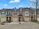Townhouse exterior featuring a brick facade, individual garages, and well-kept landscaping at 1649 Southgate Mill Dr, Duluth, GA 30096