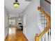 Inviting foyer with hardwood floors, staircase, and view into the living and dining areas at 1649 Southgate Mill Dr, Duluth, GA 30096