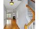 Bright hallway with hardwood floors leads to a living area with a fireplace and staircase at 1649 Southgate Mill Dr, Duluth, GA 30096