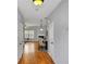 Bright hallway leading to an open-concept living area with hardwood floors and neutral decor at 1649 Southgate Mill Dr, Duluth, GA 30096