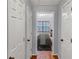 Hallway with multiple doors and a view into a bright bedroom at 1649 Southgate Mill Dr, Duluth, GA 30096