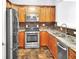 Well-equipped kitchen with stainless steel appliances, granite countertops, and ample wood cabinetry at 1649 Southgate Mill Dr, Duluth, GA 30096