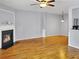 Inviting living room with hardwood flooring, modern ceiling fan, and a cozy fireplace at 1649 Southgate Mill Dr, Duluth, GA 30096