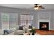 Bright living room featuring a fireplace, ceiling fan, and sliding glass door to the backyard at 1649 Southgate Mill Dr, Duluth, GA 30096