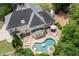 Aerial view of a private backyard oasis featuring a pool, spa, patio, and lush landscaping at 1850 Kirkmont Nw Dr, Marietta, GA 30064
