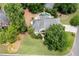 Aerial view of sprawling home with lush lawns, mature trees, landscaping, pool, and patio at 1850 Kirkmont Nw Dr, Marietta, GA 30064