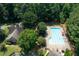 Aerial view of a large community pool, clubhouse, and surrounding green spaces, perfect for recreation at 1850 Kirkmont Nw Dr, Marietta, GA 30064