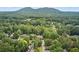 Aerial view of a neighborhood showcasing lush greenery and mountain views in the background at 1850 Kirkmont Nw Dr, Marietta, GA 30064