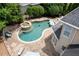 Aerial view of pool, jacuzzi, lounge chairs, patio, and a section of the home's roof at 1850 Kirkmont Nw Dr, Marietta, GA 30064