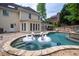 Spacious backyard with pool, patio, landscaping, and elegant home in a private setting at 1850 Kirkmont Nw Dr, Marietta, GA 30064