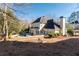 Back of house has stone trimmed kidney shaped pool with tanning spa and large yard at 1850 Kirkmont Nw Dr, Marietta, GA 30064