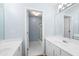 Bathroom with double sink vanity, light blue walls, and shower with glass door at 1850 Kirkmont Nw Dr, Marietta, GA 30064