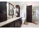 Bathroom features dark wood cabinets, quartz countertops, soaking tub and tiled shower at 1850 Kirkmont Nw Dr, Marietta, GA 30064