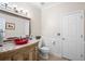 Bathroom featuring a red bowl sink on a carved vanity cabinet and decorative mirror at 1850 Kirkmont Nw Dr, Marietta, GA 30064