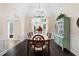 Dining room with modern chandelier, hardwood floors, and view to living room at 1850 Kirkmont Nw Dr, Marietta, GA 30064