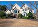 Stunning two-story home with a stone facade, arched window, and mature landscaping at 1850 Kirkmont Nw Dr, Marietta, GA 30064