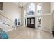 Elegant foyer with soaring ceilings, grand staircase, and stylish lighting fixture at 1850 Kirkmont Nw Dr, Marietta, GA 30064