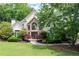 Lush front lawn and landscaping showcase this beautiful home's stone entryway and architecture at 1850 Kirkmont Nw Dr, Marietta, GA 30064