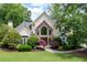 Lush front lawn and landscaping highlight this home's stone entryway and architectural details at 1850 Kirkmont Nw Dr, Marietta, GA 30064