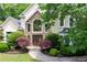 Beautiful home exterior with lush landscaping, stone accents, and an inviting entryway at 1850 Kirkmont Nw Dr, Marietta, GA 30064