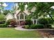 Charming two-story home with stone accents, manicured lawn and mature trees at 1850 Kirkmont Nw Dr, Marietta, GA 30064