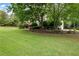 Spacious front yard with lush green lawn, mature trees, and well-maintained landscaping at 1850 Kirkmont Nw Dr, Marietta, GA 30064
