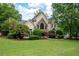 Charming two-story home with stone accents, manicured lawn and mature trees at 1850 Kirkmont Nw Dr, Marietta, GA 30064
