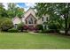 Charming two-story home with stone accents, manicured lawn and mature trees at 1850 Kirkmont Nw Dr, Marietta, GA 30064