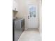 Laundry room with stainless steel washer and dryer, utility sink, and tile flooring at 1850 Kirkmont Nw Dr, Marietta, GA 30064