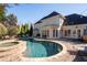 Back of house with large windows overlooks a stone trimmed kidney shaped pool with tanning spa at 1850 Kirkmont Nw Dr, Marietta, GA 30064