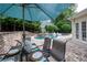 Outdoor dining area with umbrella and manicured lawn overlooking pool with swan floats at 1850 Kirkmont Nw Dr, Marietta, GA 30064